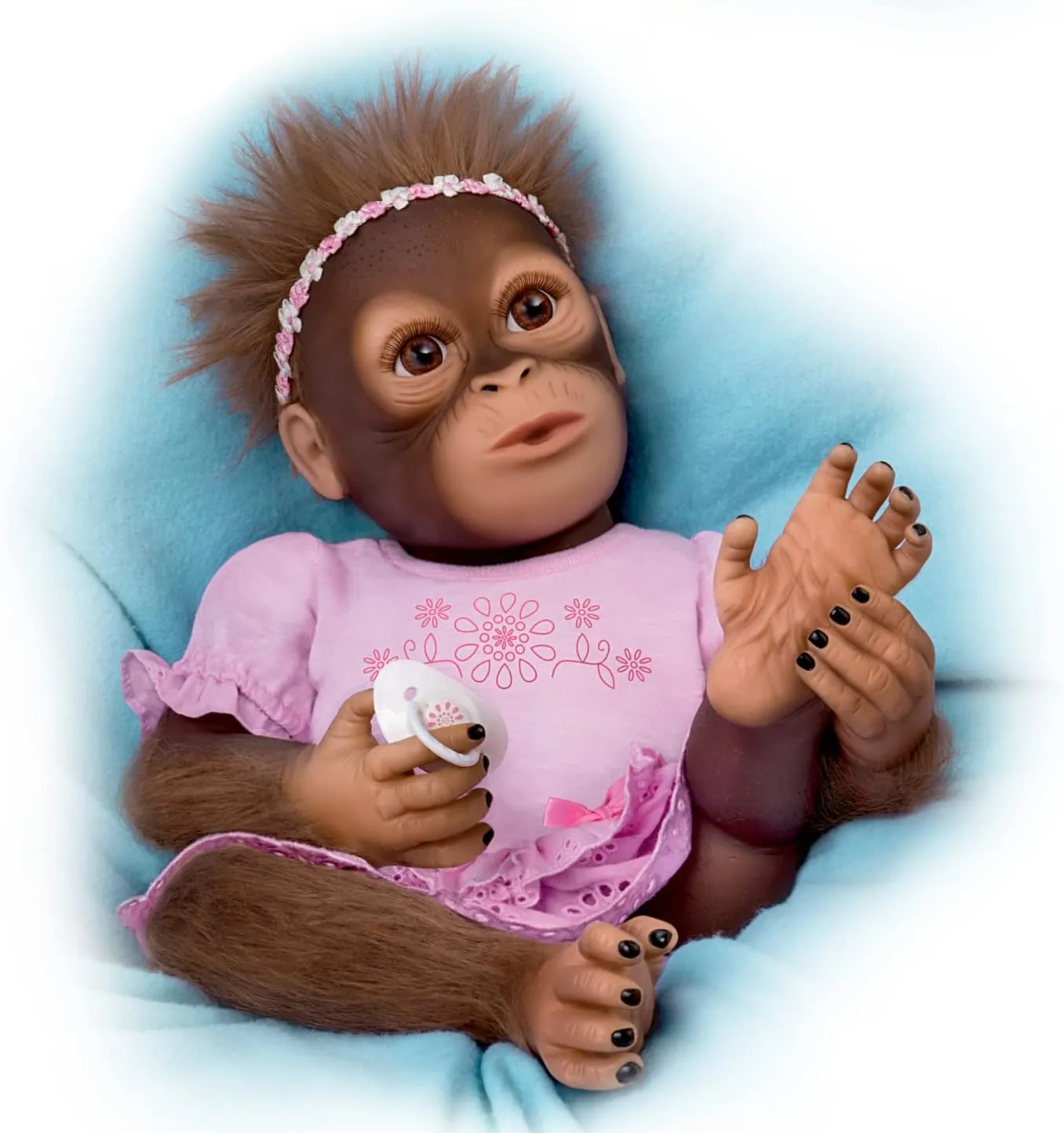 The Ashton-Drake Galleries Cooing Cora Vinyl Monkey Baby Doll, Touch Activated with Breathing Motion & Magnetic Pacifier Featuring Hand-Applied Mohair, 18 Inches (Brown, Pink)